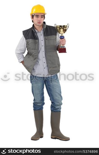 Builder proudly holding trophy