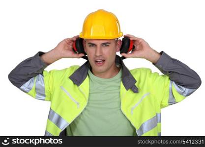 Builder removing earmuffs