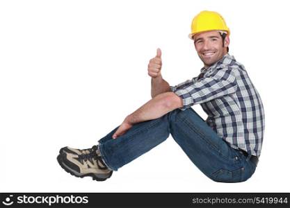 Builder sat down giving thumbs-up