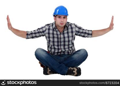 Builder sat on floor cross-legged
