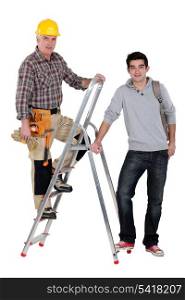 Builder stood on ladder next to apprentice