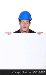 Builder stood with blank poster