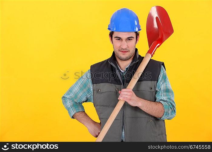 Builder stood with spade