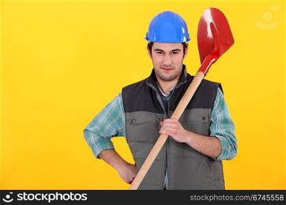 Builder stood with spade