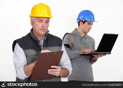 Builder stood with young apprentice
