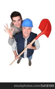 Builder stood with young apprentice