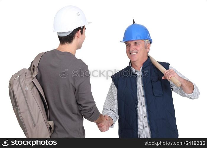 Builder welcoming teenage helper