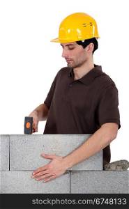 Builder with a block wall