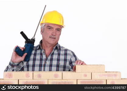 Builder with a masonry drill