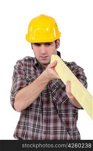 Builder with a plank of wood