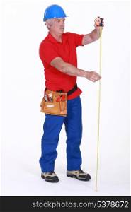 Builder with a tape measure