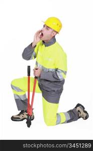 Builder with bolt cutter shouting