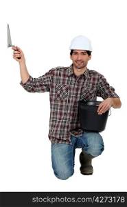 Builder with bucket and trowel