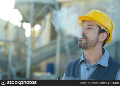builder worker with a cigarette smoke break
