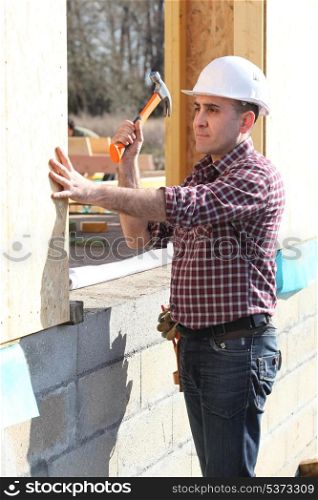 Builder working on a house