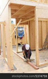 Builder working on a wooden structure