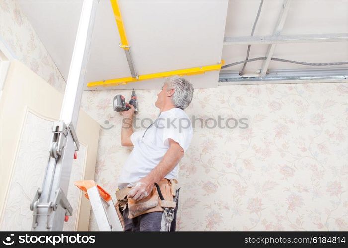 Builder working on ceiling