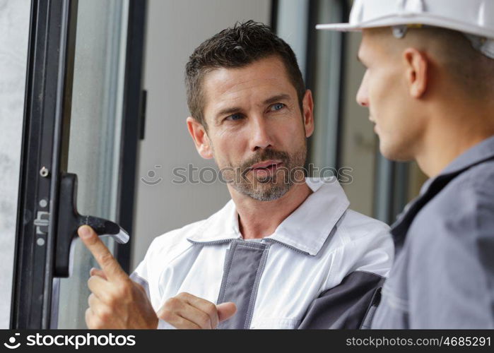 builders checking a window