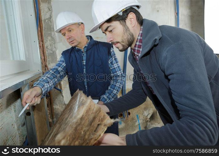 builders checking mineral wool panels stack