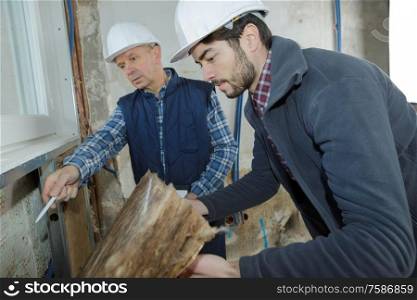 builders checking mineral wool panels stack