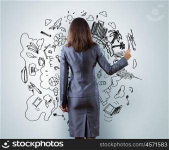Building a business. Back view of businesswoman drawing sketches with marker