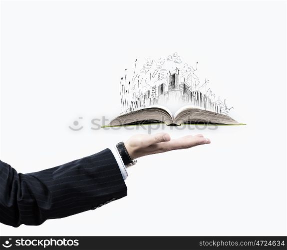 Building a city. Businessman hand holding opened book in palm