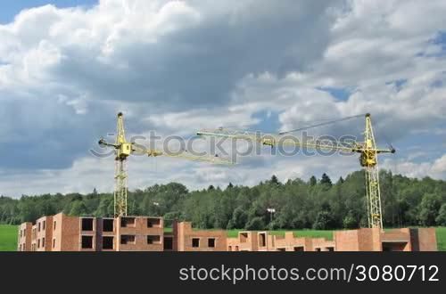 Building big living house from scratch, real image on background of cloudy sky near forest. Animation, original color and design changed