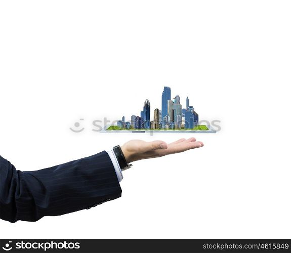 Building business. Close up of human hand holding tablet pc with city image