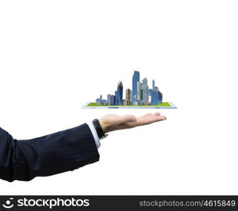 Building business. Close up of human hand holding tablet pc with city image