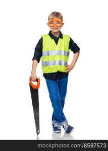 building, carpentry and profession concept - happy smiling little boy in protective helmet and safety vest and goggles with saw over white background. little boy in safety vest and goggles with saw
