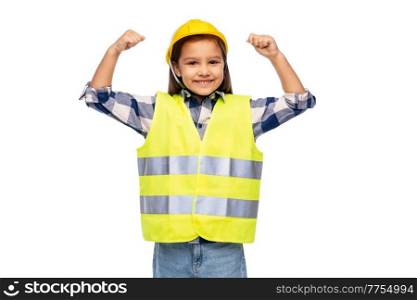 building, construction and girl power concept - smiling little girl in protective helmet and safety vest showing her strong arms over white background. girl in helmet and safety vest showing power