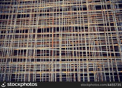 building, construction and material concept - close up of rusty carcass grid