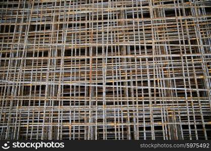 building, construction and material concept - close up of rusty carcass grid