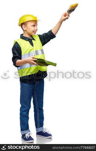 building, construction and profession concept - happy smiling little boy in protective helmet and safety vest with brush and tray painting something imaginary over white background. little boy in protective helmet with brush
