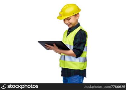 building, construction and profession concept - happy smiling little boy in protective helmet and safety vest with tablet pc computer over white background. boy in construction helmet with tablet computer