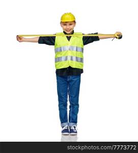 building, construction and profession concept - happy smiling little boy in protective helmet and safety vest with ruler over white background. boy in construction helmet and vest with ruler