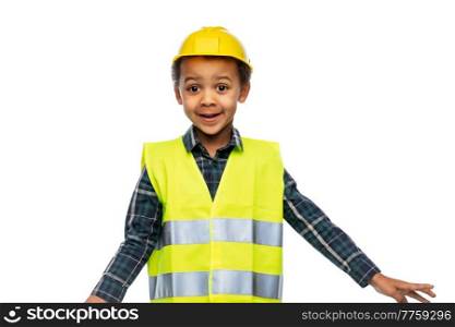 building, construction and profession concept - happy smiling little boy in yellow safety vest and helmet over white background. little boy in safety vest and construction helmet
