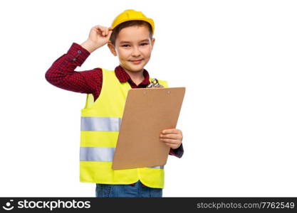 building, construction and profession concept - little boy in protective helmet and safety vest with clipboard over white background. little boy in construction helmet with clipboard