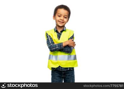 building, construction and profession concept - portrait of smiling little boy in yellow safety vest with crossed arms over white background. little boy in safety vest with crossed arms
