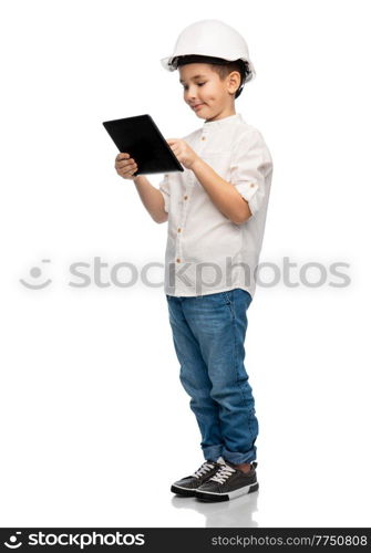 building, construction and profession concept - smiling little boy in helmet with tablet pc computer over white background. little boy in construction helmet with tablet pc