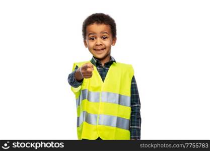 building, construction and profession concept - smiling little boy in yellow safety vest pointing finger to camera over white background. little boy in safety vest over white background