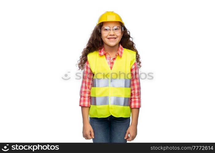 building, construction and profession concept - smiling little girl in goggles, protective helmet and safety vest over white background. little girl in construction helmet and safety vest