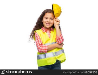 building, construction and profession concept - smiling little girl in protective helmet and safety vest over white background. little girl in construction helmet and safety vest