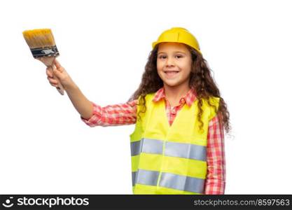 building, construction and profession concept - smiling little girl in protective helmet and safety vest with paint brush over white background. girl in helmet and safety vest with paint brush