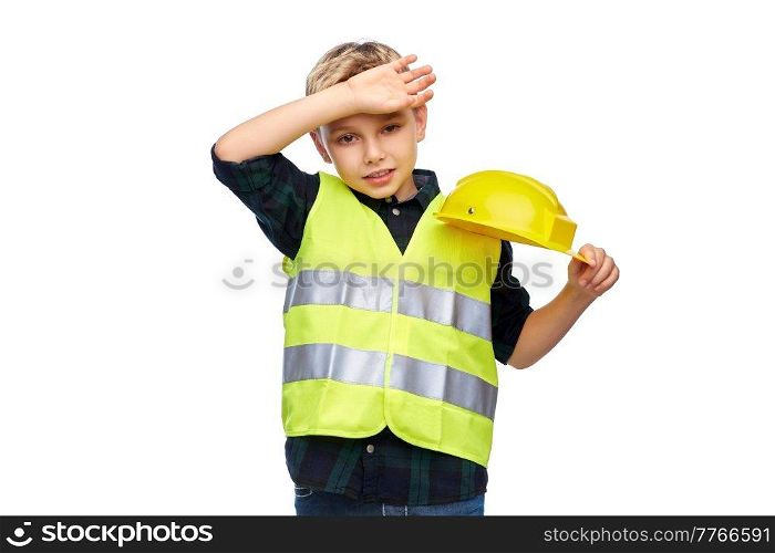 building, construction and profession concept - tired little boy in protective helmet and safety vest over white background. tired boy in protective helmet and safety vest