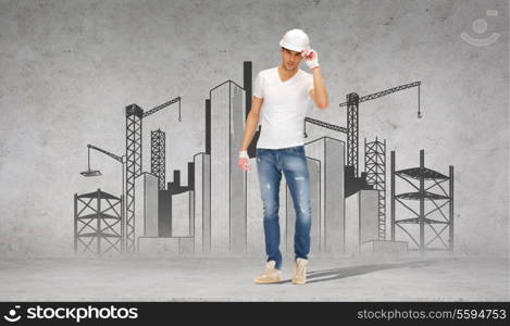building, construction and renovation concept - handsome builder in helmet and gloves