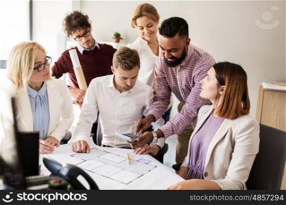 building, construction, architecture, real estate and people concept - business team with blueprint and calculator working with house project at office
