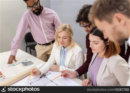 building, construction, architecture, real estate and people concept - business team with blueprint meeting and discussing house project at office. business team discussing house project at office