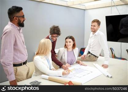 building, construction, architecture, real estate and people concept - happy business team with blueprint meeting and discussing house project at office. business team discussing house project at office