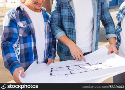 building, construction, development, teamwork and people concept - close up of two smiling builders with blueprint outdoors